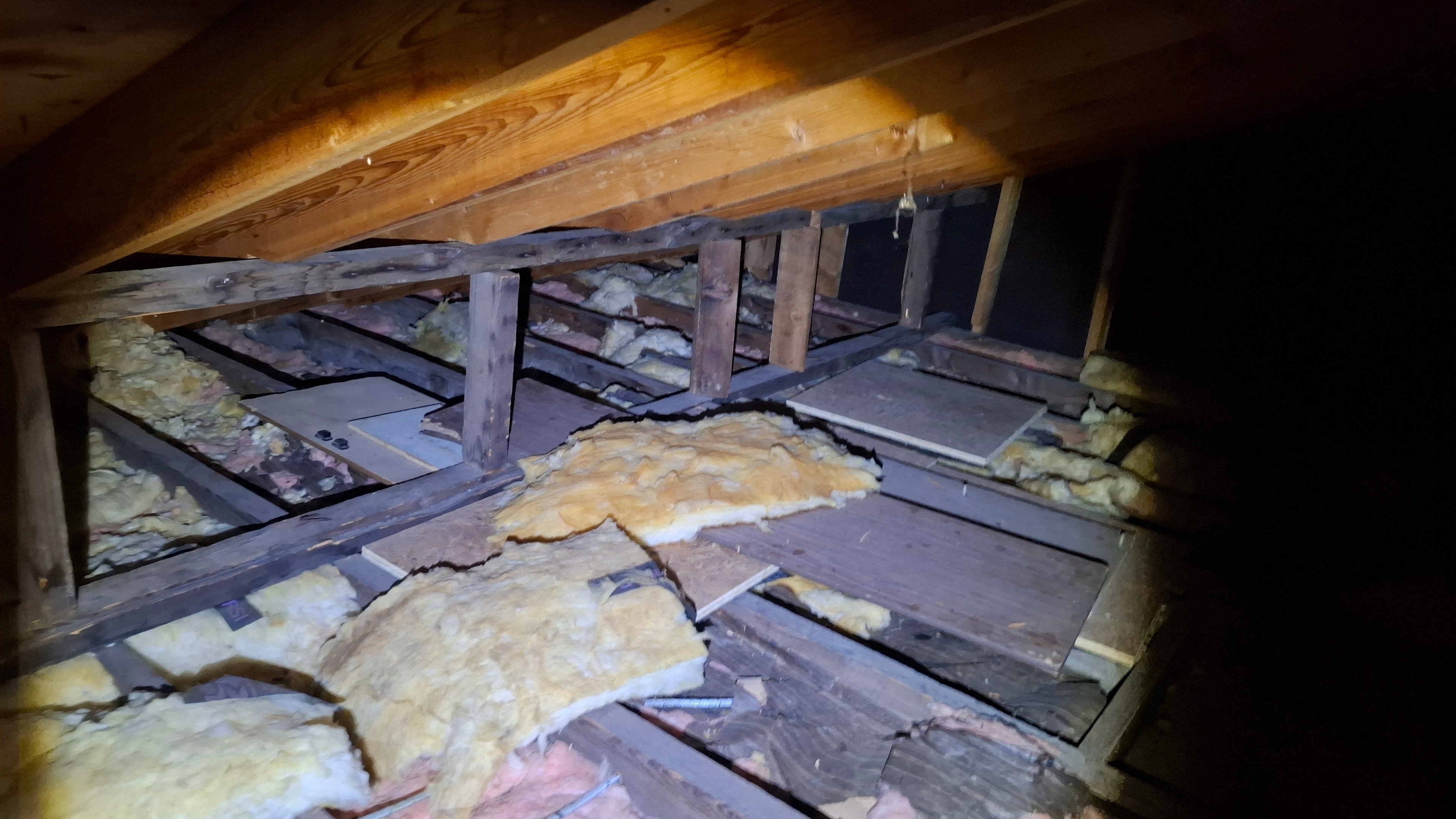 Attic before blown-in cellulose installation — existing insulation and framing visible