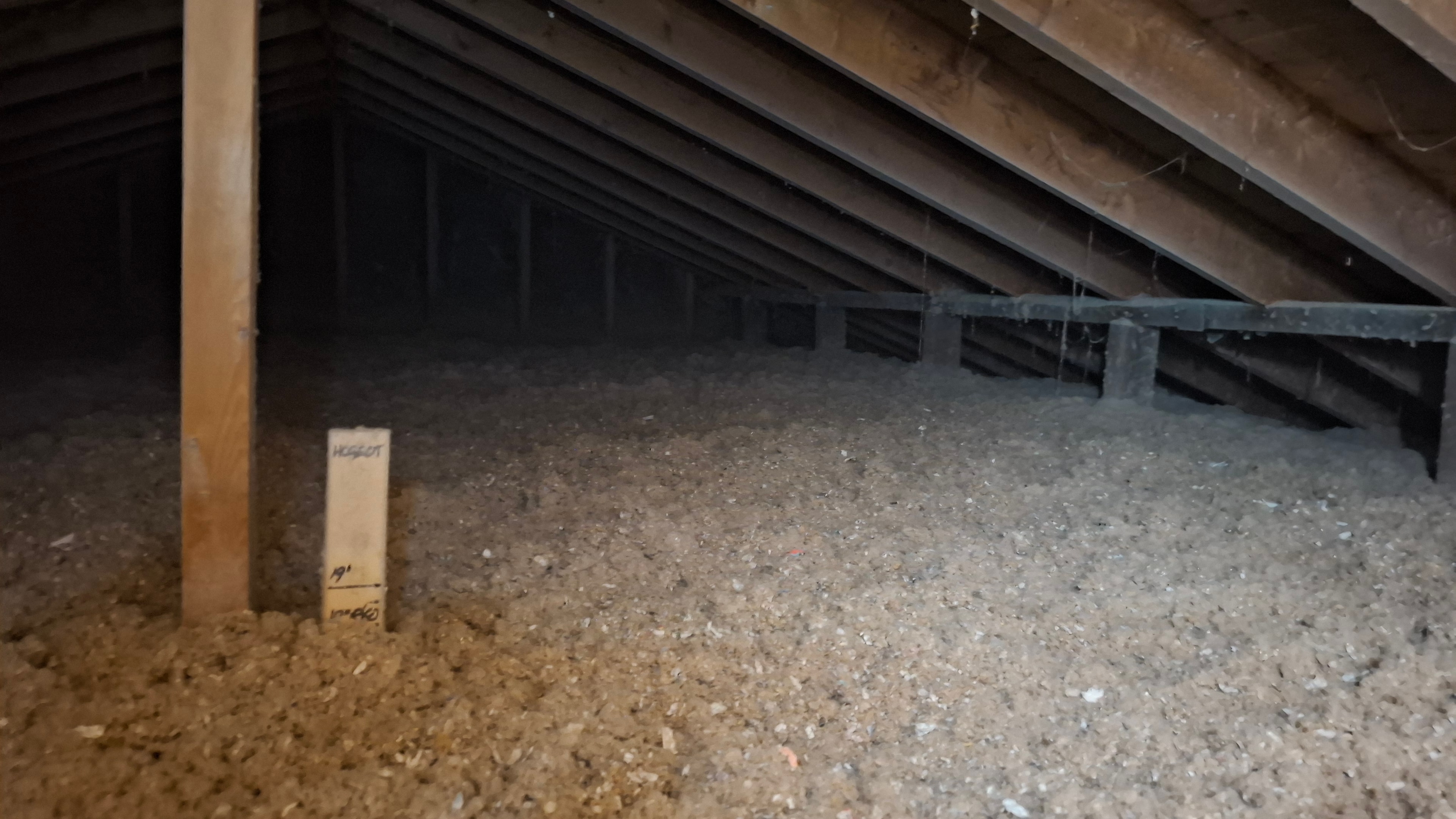 HCGEOT R60 depth marker confirming blown-in cellulose insulation depth after installation