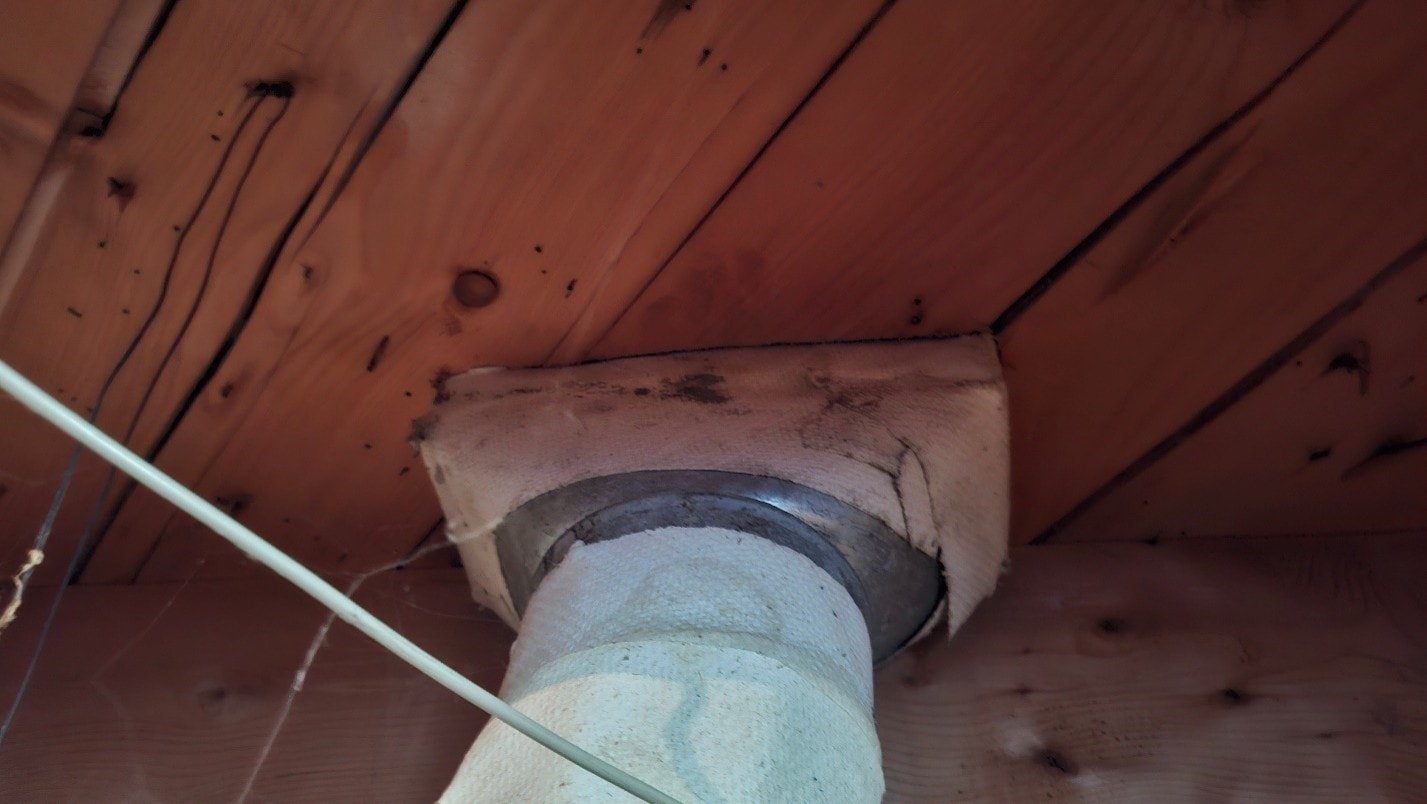 ACM asbestos-containing paper insulation on heat register vent — residential Ottawa property
