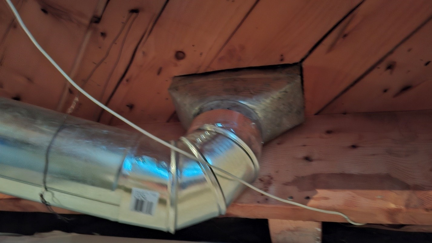 New round duct connected to register boot through floor framing — after abatement