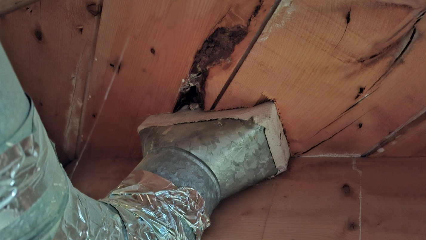 ACM paper on heat register vent with foil flex duct connection — before removal