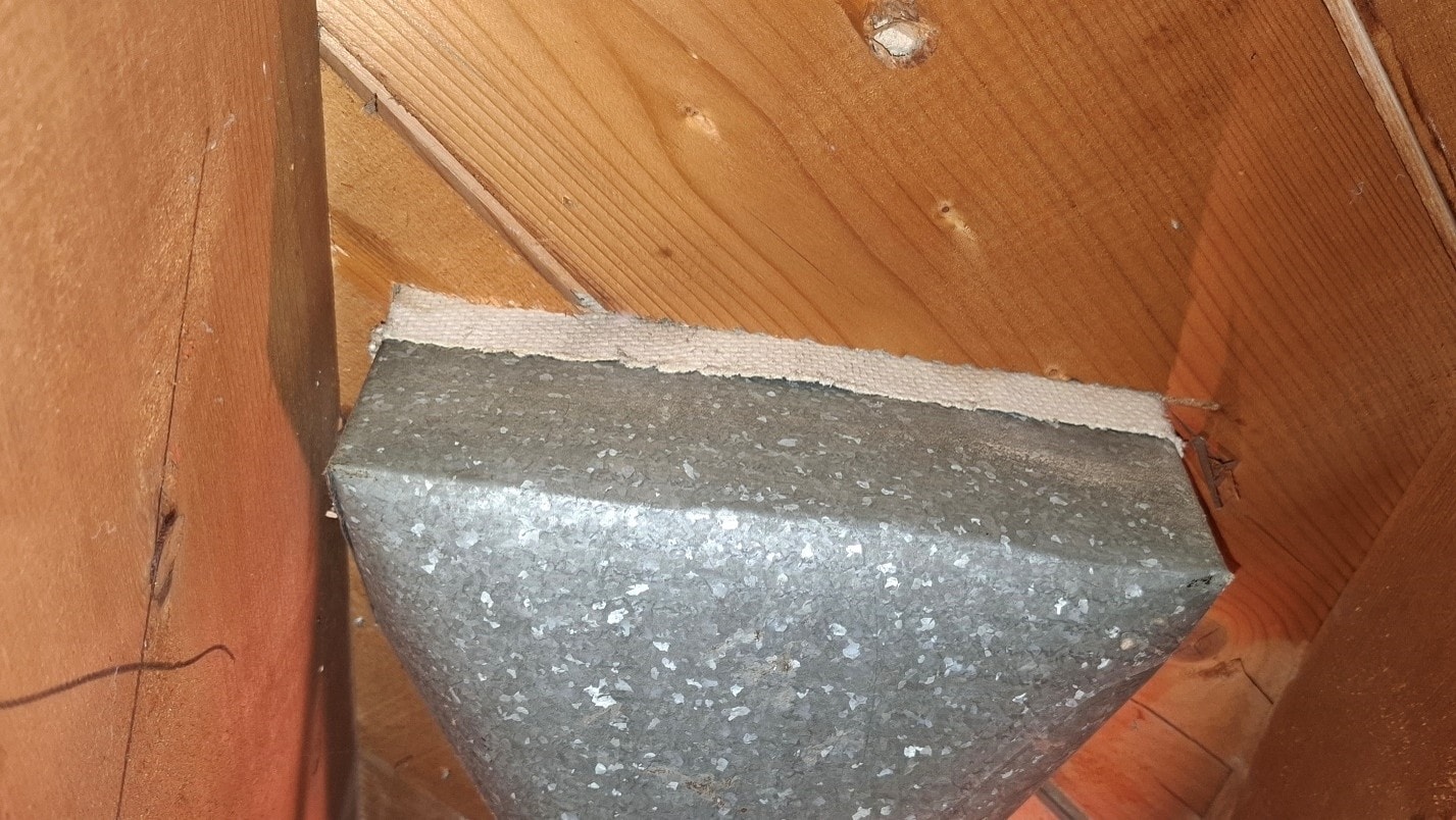 ACM paper on rectangular HVAC duct boot — close-up before abatement