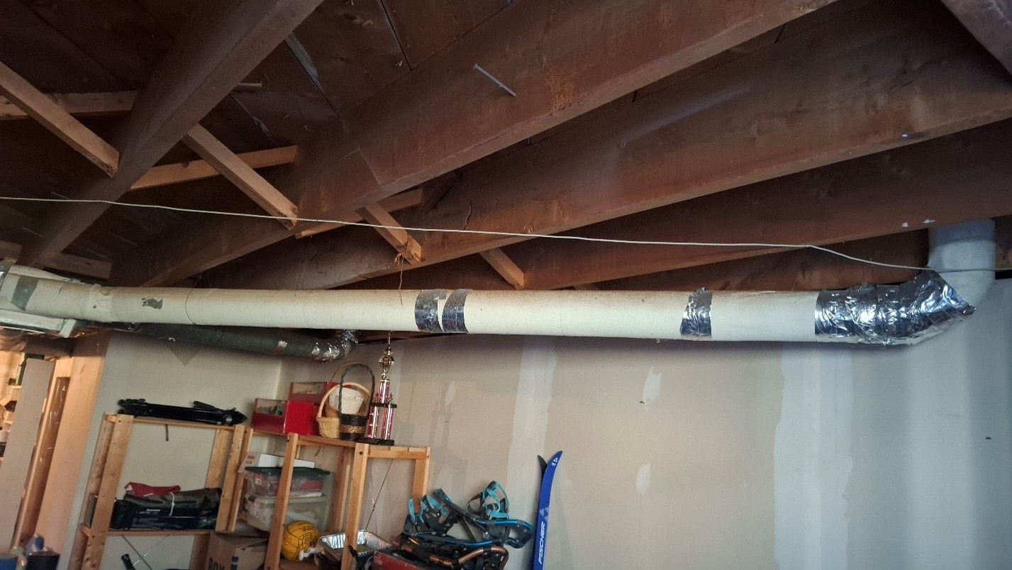 New replacement ductwork installed in basement ceiling after ACM abatement