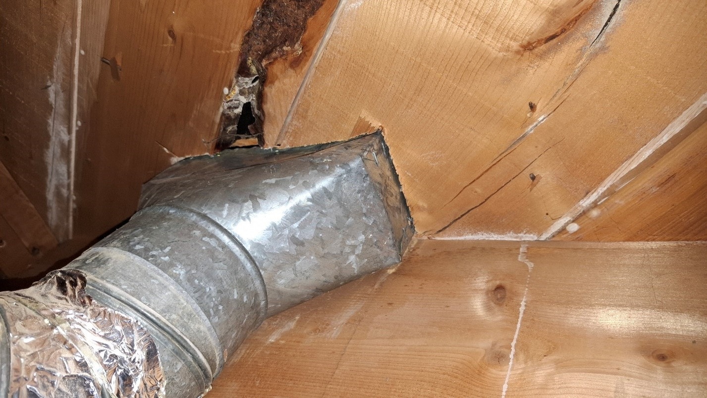 Heat register vent after ACM paper removal — clean bare metal duct exposed