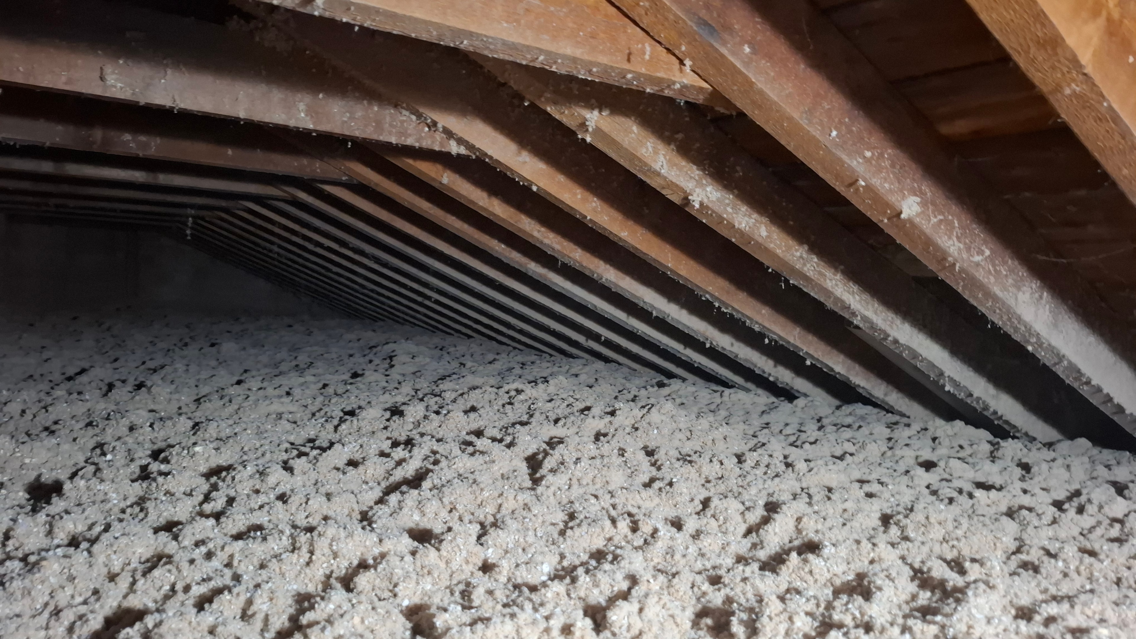 Completed R-50 cellulose insulation filling attic to full depth