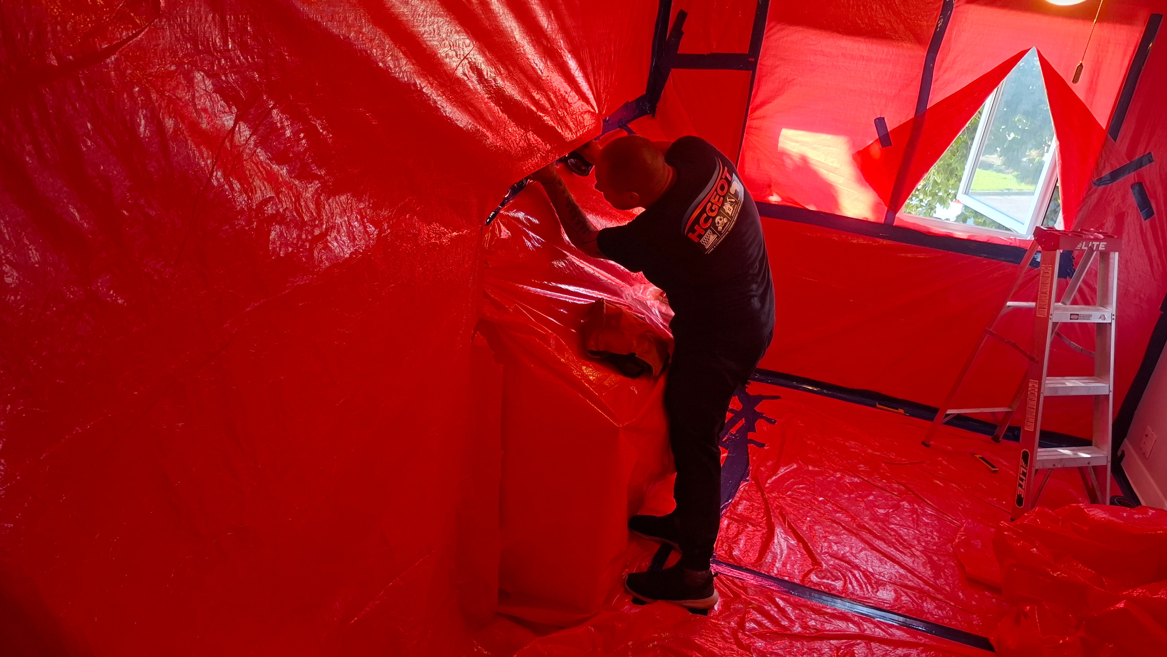 HCGEOT technician inside Type 3 asbestos containment during vermiculite removal — Ottawa residential attic
