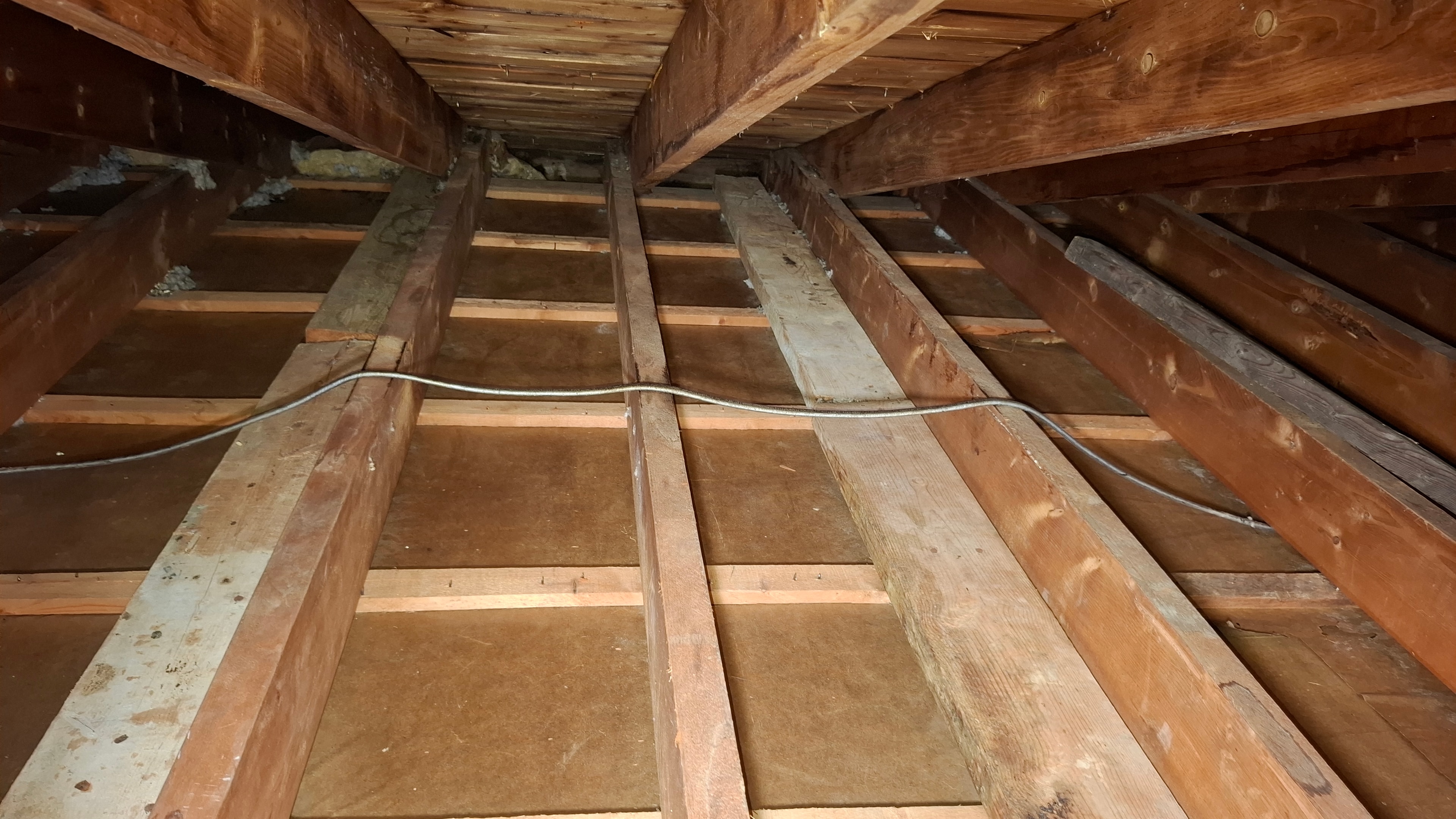 Attic framing after asbestos abatement — clean rafters and sheathing prior to reinsulation — Ottawa