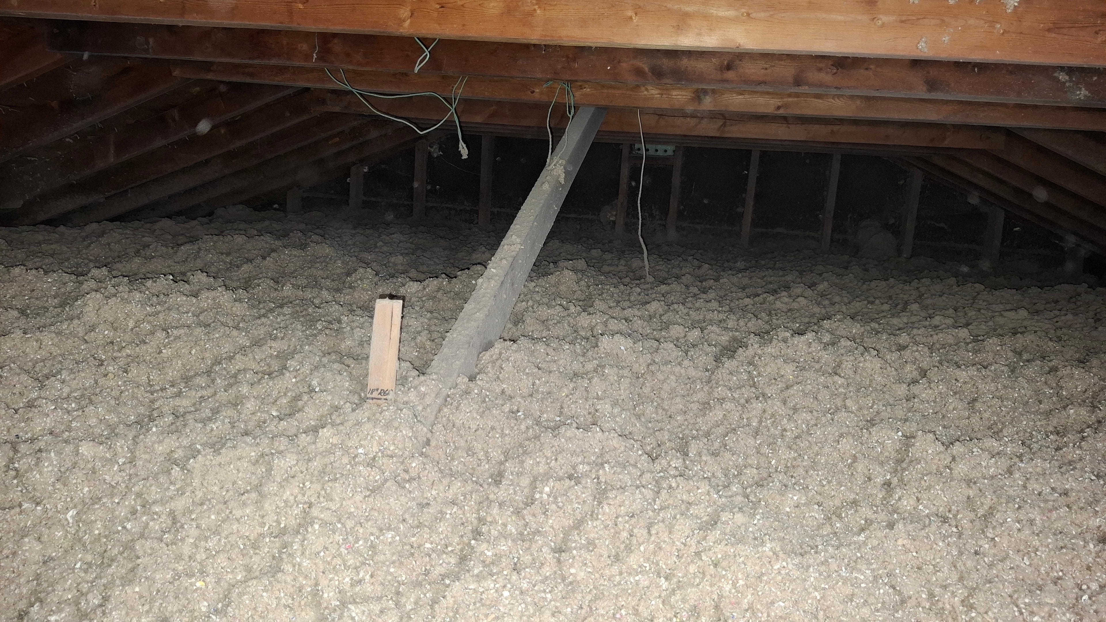Completed attic with new blown-in cellulose insulation installed after vermiculite removal